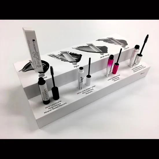 White cosmetics counter display with mascara swatches