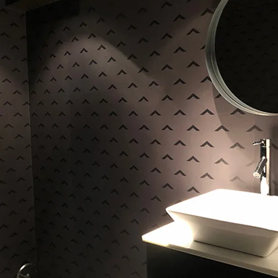 Dark patterned wallcovering in an upscale washroom